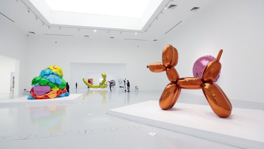 Visitors inside the galleries of the exhibition Jeff Koons: Lost In America