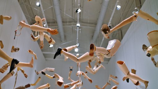 Close up of Kader Attia's artwork of mannequin limbs suspended above