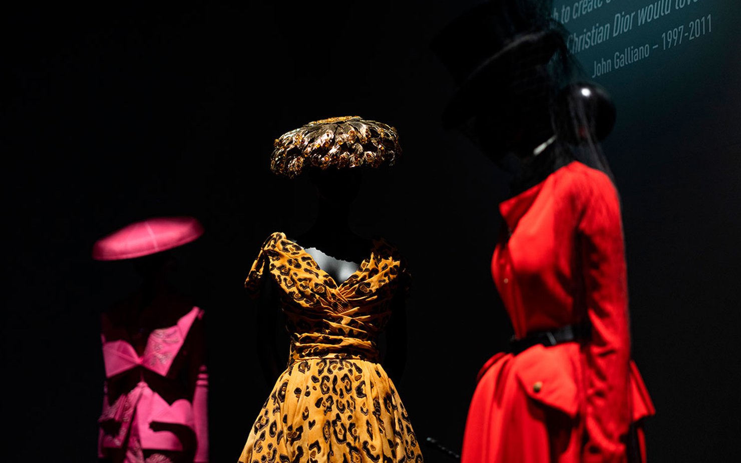 Three vibrant looks by John Galliano for Dior, featuring a leopard-print dress in the centre