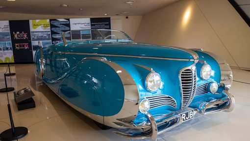 The aqua blue Delahaye 175 S Roadster car displayed at the National Museum of Qatar gallery space