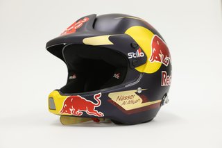 A race helmet with the name Nasser Al Attiyah stapled to its side