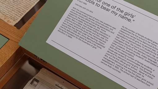 image of the amna al Jaidah exhibition close up on object diploma and news articles
