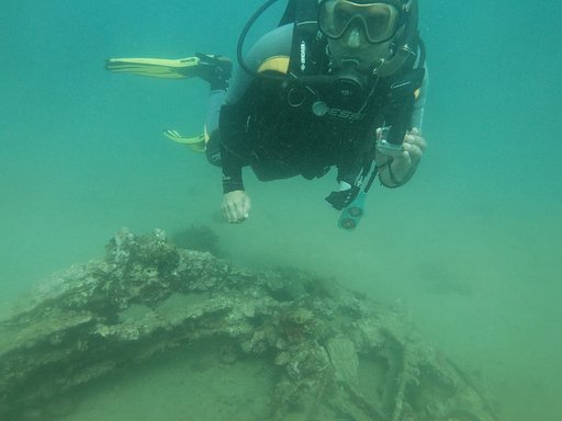 A figure underwater exploring the oceans archeology