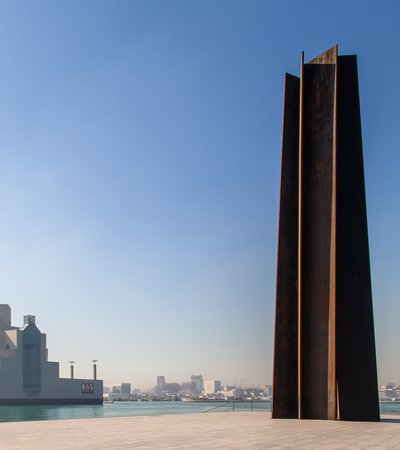 A wide-angle view of Richard Serra's sculpture '7' located right outside the Museum of Islamic Art, Doha