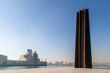 A wide-angle view of Richard Serra's sculpture '7' located right outside the Museum of Islamic Art, Doha