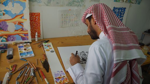 Artist in residence Abdulla Al-Kuwari working in his studio at the Fire Station.