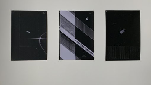 Artworks on a wall in an exhibition.