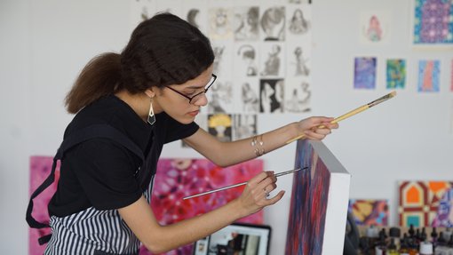 Artist Sarah Al-Ansari working in her studio at the Fire Station.