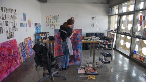 Artist Sarah Al-Ansari working in her studio.