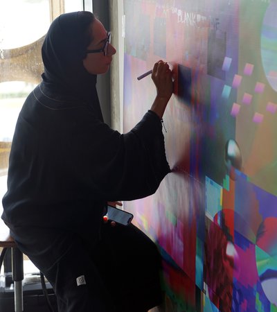 Artist in residence Shaikha Al-Hardan working in her studio.