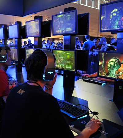 Teenagers play the latest version of Starcraft at the Gamescom convention in Cologne, Germany.