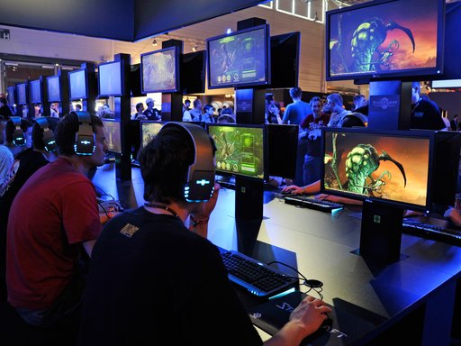 Teenagers play the latest version of Starcraft at the Gamescom convention in Cologne, Germany.