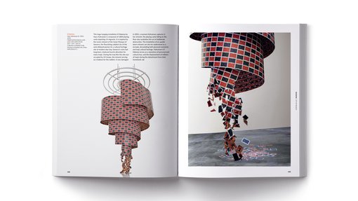 Two pages of a book showing an image of a large hanging installation of playing cards