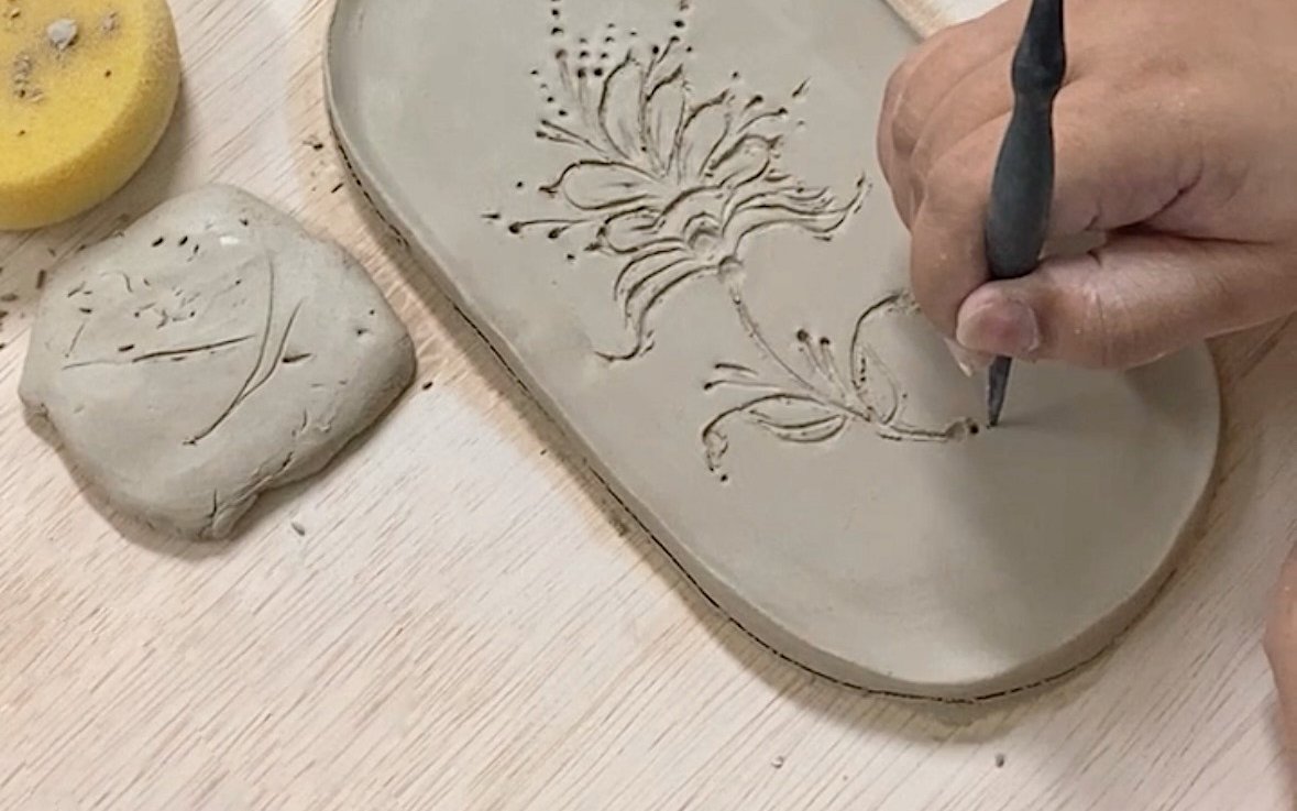 hand making tray from clay