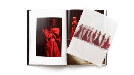 Two page spread of the Forever Valentino exhibition catalogue featuring red dresses