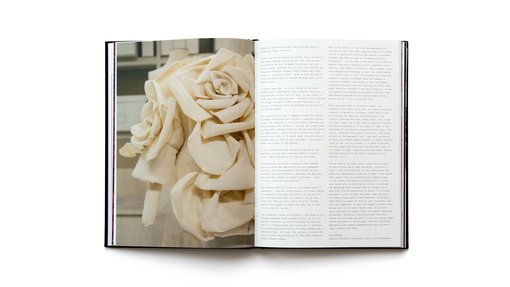 Two page spread of the Forever Valentino exhibition catalogue featuring one of Valentino's looks