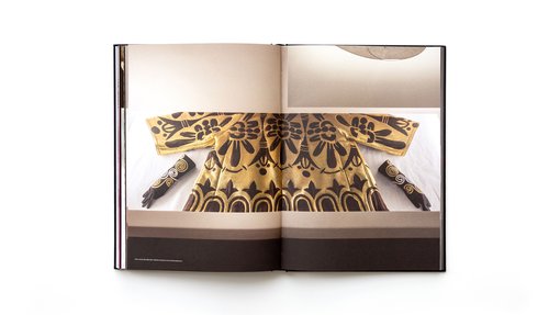 Two page spread of the Forever Valentino exhibition catalogue featuring a Valentino garment