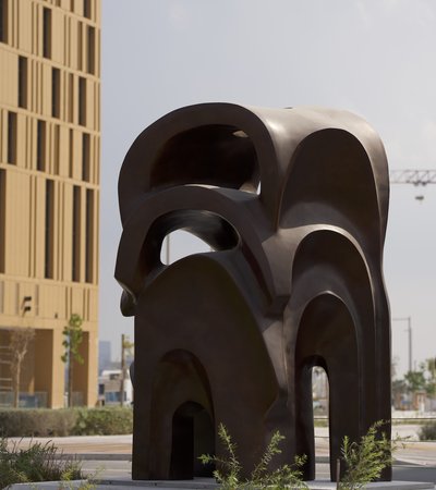 Dark brown large sculpture of arches placed on top of each other