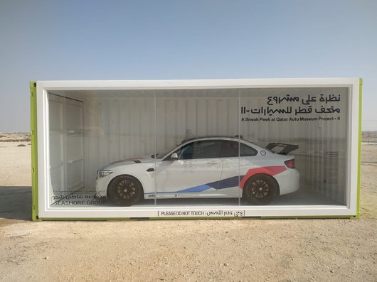 A 2022 white BMW M2 CS Racing car in a display box.