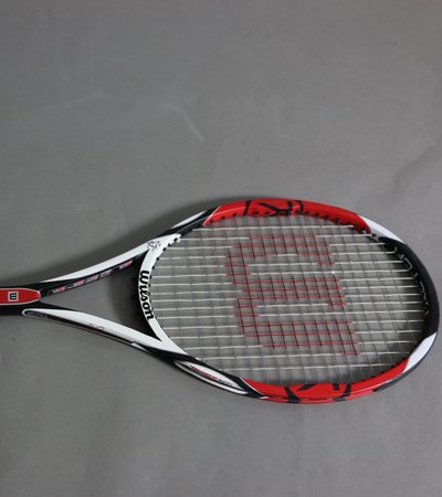 A black, red and white Wilson racquet signed by renowned tennis player Roger Federer.