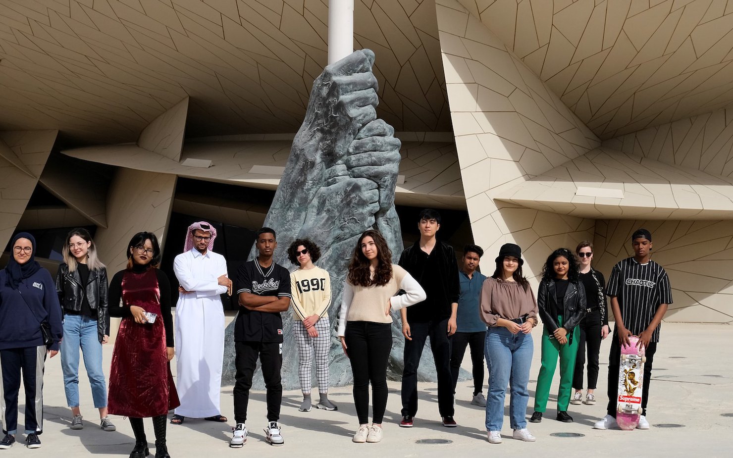 Teens standing in front of the National Museum of Qatar
