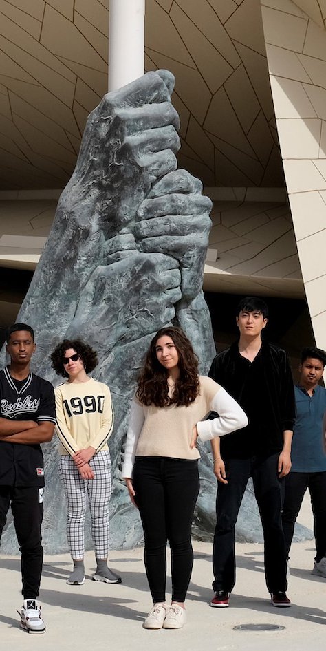 Teens standing in front of the National Museum of Qatar