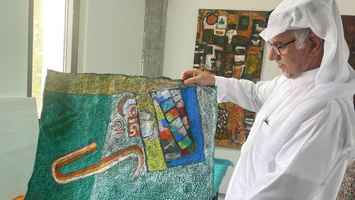 Ruwad Artist Hassan Al-Mulla showing his artworks on paper in his studio at the Fire Station.