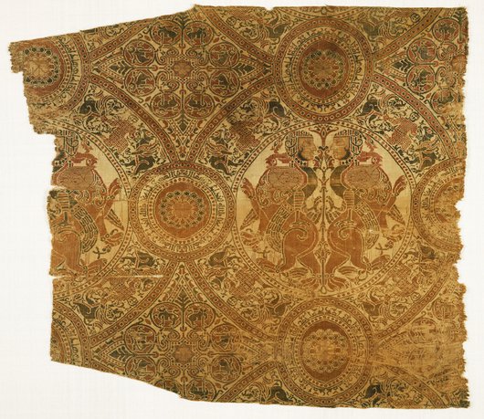Gold coloured textile fragment with lion and harpy motifs