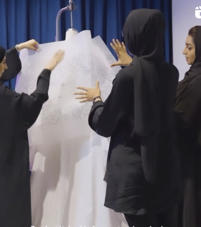 women dressing a mannequin