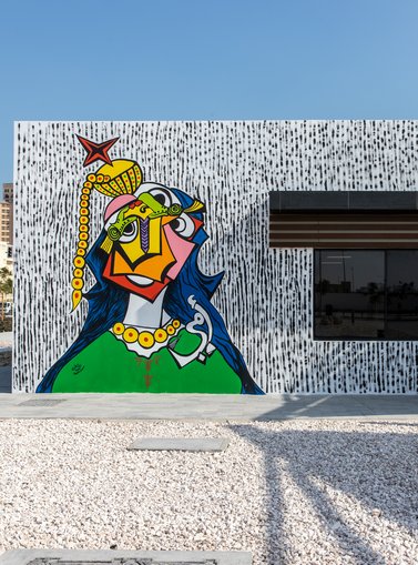 A mural depicting a Qatari woman figure in a cubist fashion