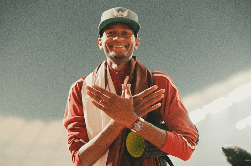 athlete Mutaz Barshim standing with a smile
