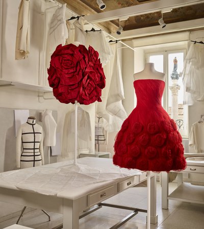 Two red Valentino dresses placed on mannequins in the Valentino workroom.