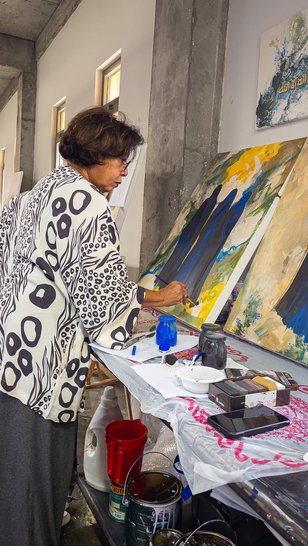 Ruwad Artist Wafika Sultan Al-Essa working in the corner of her studio at the Fire Station.