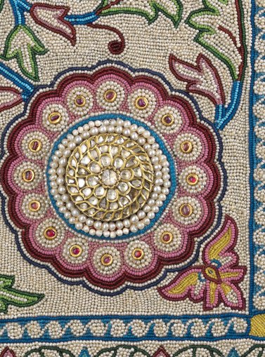 Part of the distinctive Baroda carpet is a circular rose embroidered with a diamond stone placed on a ground of gold and silver
