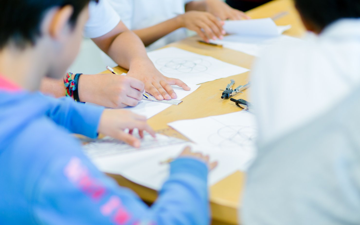 Children drawing shapes at a workshop