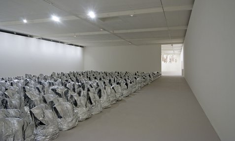 Installation called Ghost that showcases multiple aluminium foil ghost-like figures