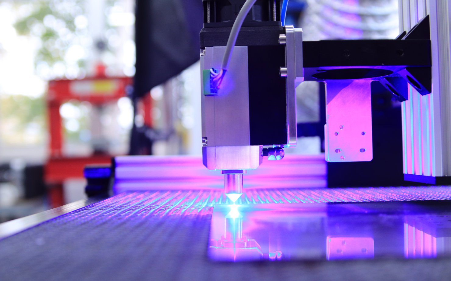 Neon lights shining through the laser printing machine in action