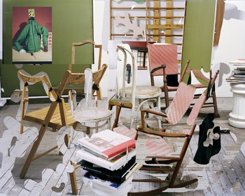 A photographic montage with several chairs arranged in a space.