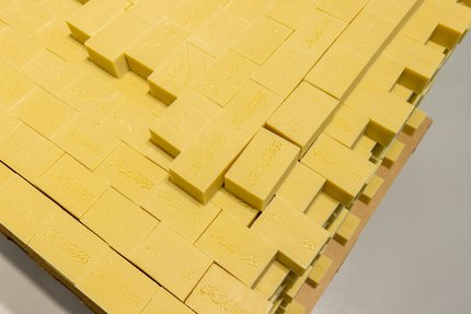 Yellow bricks of soap stacked on top of each other.