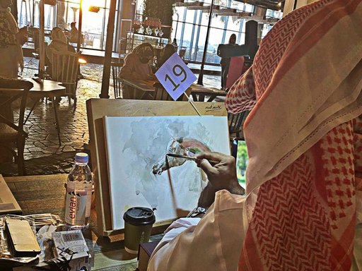 A man in traditional Qatari garb paints a colourful horse on canvas
