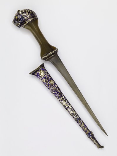 A dagger and scabbard featuring floral engravings and a tiger's head on the handle.