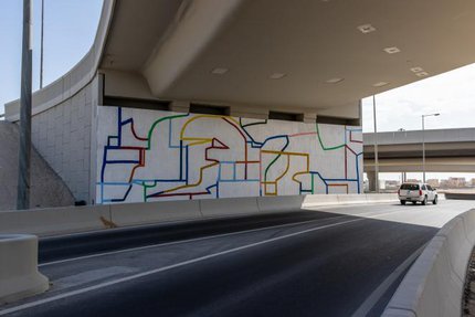 A mural depicting broken walls using abstract coloured lines.