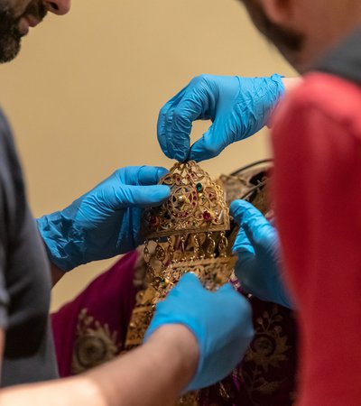 Conservator-restorer handling a gold object for the National Museum of Qatar