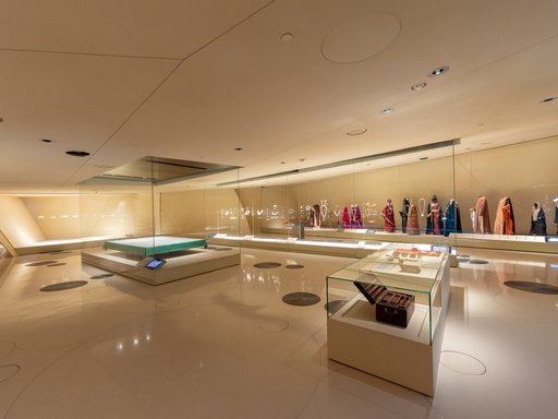 Gallery space at the National Museum of Qatar showcasing traditional dresses, carpets and jewelry
