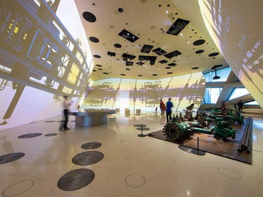 Interior of a gallery space at the National Museum of Qatar showcasing oil platform machinery