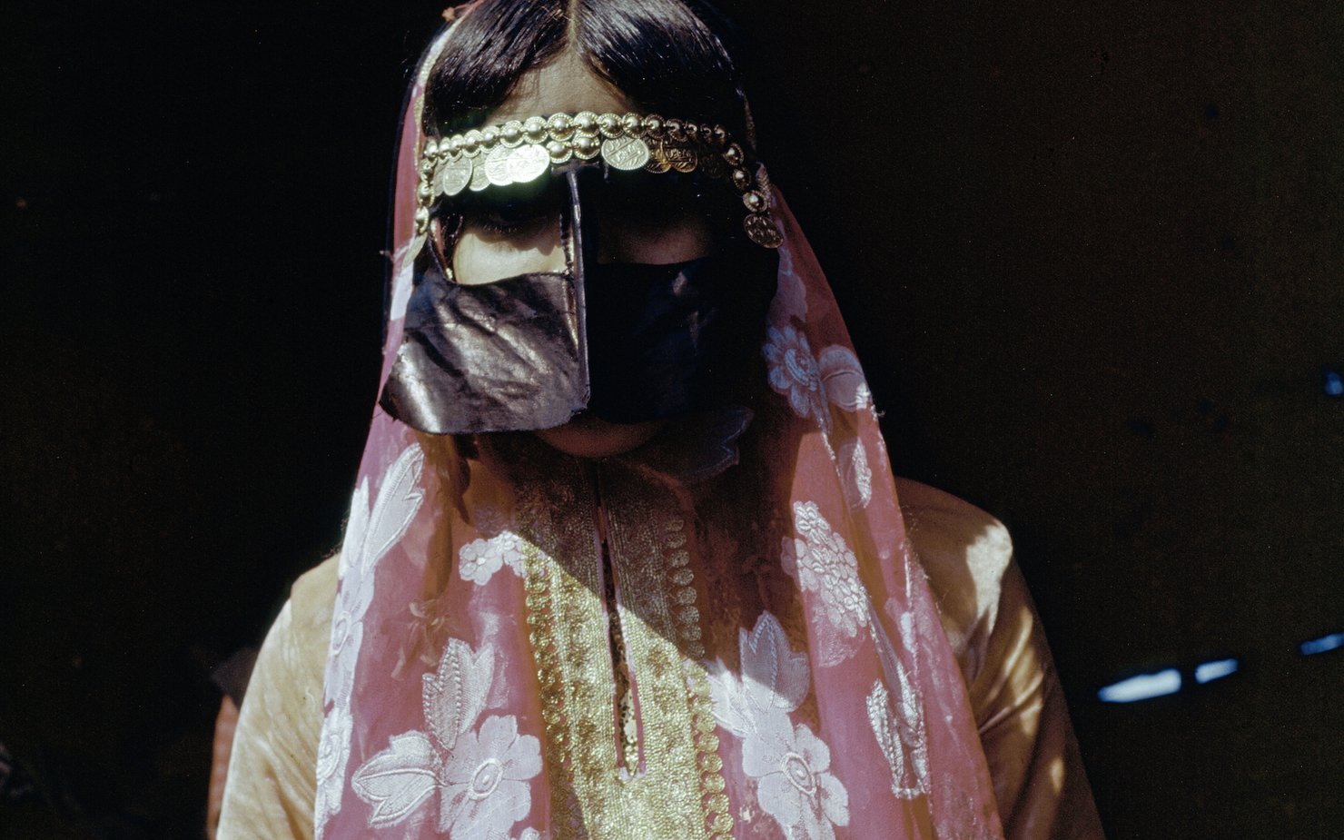 Woman wearing traditional Qatari dress and face covering