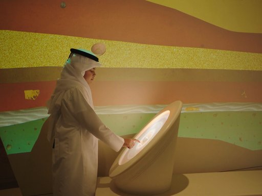 Qatari boy interacting with a digital display at the National Museum of Qatar