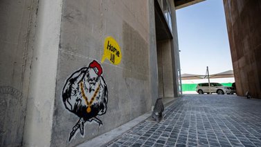 A mural depicting a dove wearing a hat and a chain necklace shouting the word ''Home!!!''