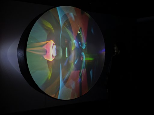 A circular projection screen displaying colourful lights.