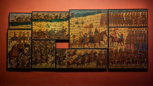 Eight paintings connected together, depicting war times at 'One Tiger or Another' exhibition